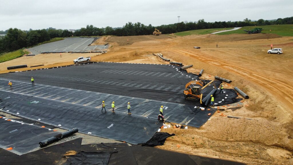 IDS Geosynthetic Cover System installation, showing workers and equipment executing the project